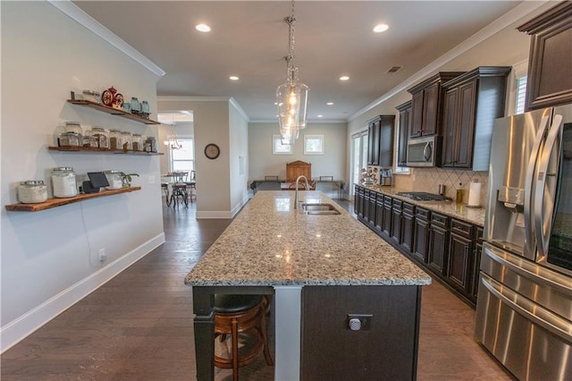 6390 Yellow Birch St, Cumming, GA 30040 - kitchen with appliances with stainless steel finishes, a sink, crown molding, plenty of natural light, and a breakfast bar