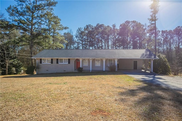 ranch-style home with a front yard and a carport