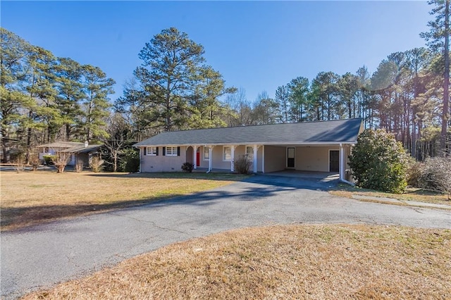 single story home with a carport and a front lawn