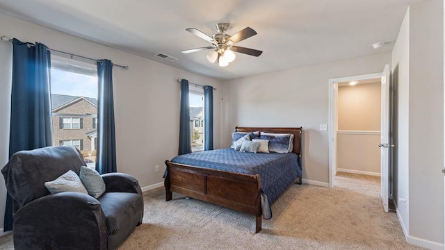 bedroom featuring light colored carpet and ceiling fan