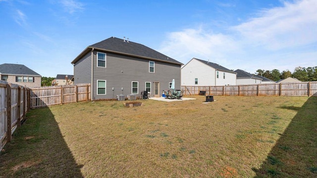 back of house featuring central air condition unit, a lawn, and a patio