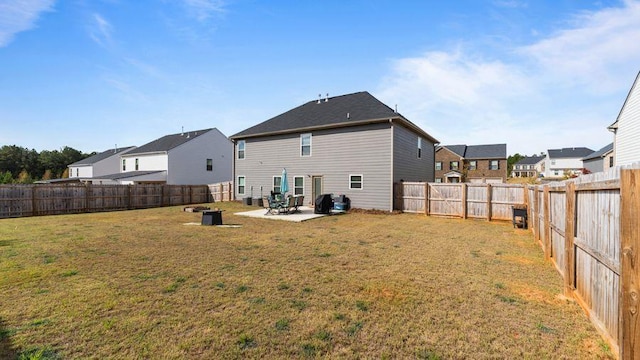 back of property featuring a lawn and a patio