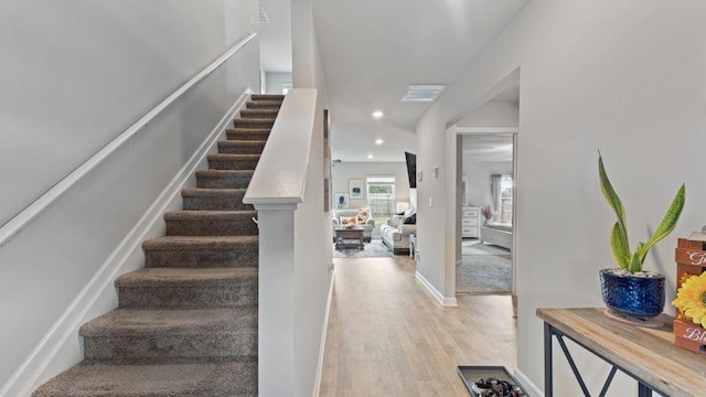 staircase with hardwood / wood-style floors