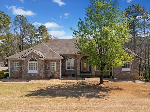 19 Spring Lake Trl NE, White, GA 30184 - view of front facade featuring a shingled roof, brick siding, and a front yard