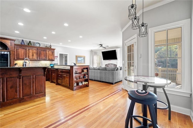 19 Spring Lake Trl NE, White, GA 30184 - kitchen featuring a kitchen island with sink, a ceiling fan, crown molding, light wood-type flooring, and recessed lighting