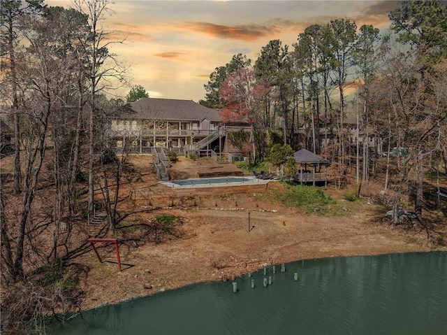 19 Spring Lake Trl NE, White, GA 30184 - back of house at dusk with a deck with water view