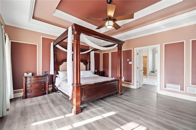 19 Spring Lake Trl NE, White, GA 30184 - bedroom with a tray ceiling, wood finished floors, crown molding, ensuite bathroom, and baseboards