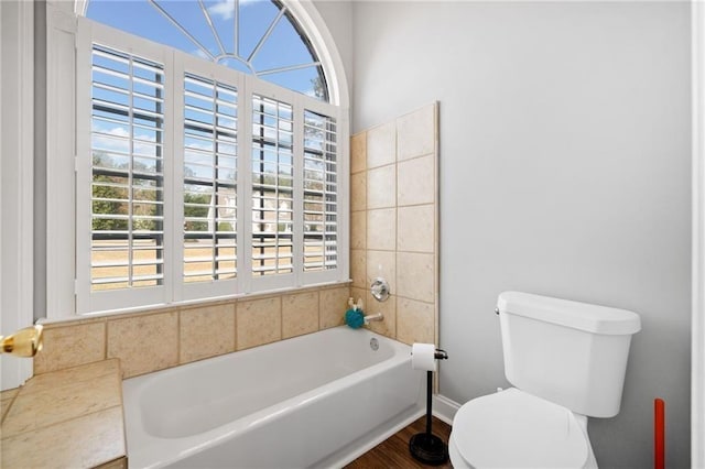 19 Spring Lake Trl NE, White, GA 30184 - full bathroom featuring toilet, healthy amount of natural light, a tub, and wood finished floors