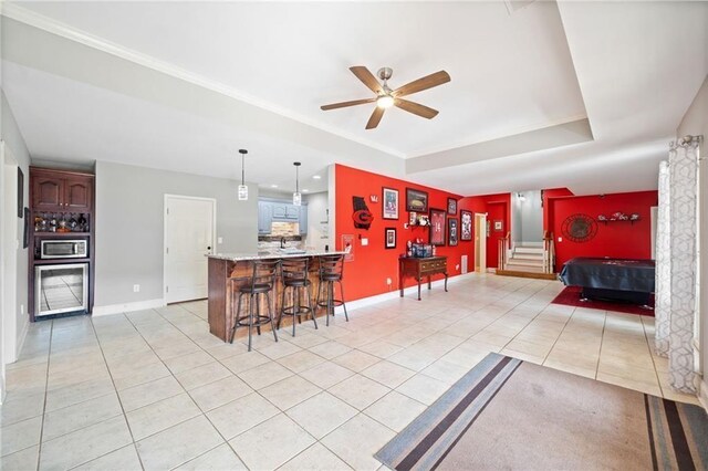 19 Spring Lake Trl NE, White, GA 30184 - kitchen with light tile patterned floors, a kitchen breakfast bar, ceiling fan, light countertops, and a peninsula