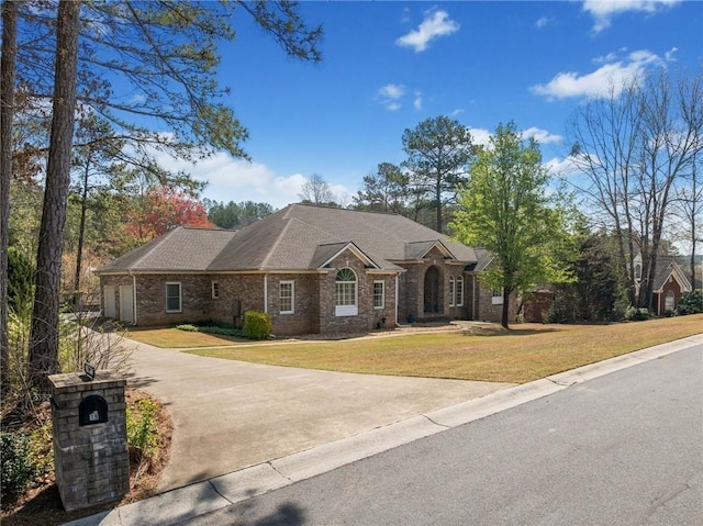 19 Spring Lake Trl NE, White, GA 30184 - view of front of home featuring a front yard, concrete driveway, and brick siding