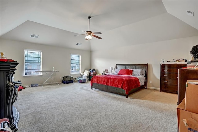 bedroom featuring visible vents, vaulted ceiling, and light colored carpet