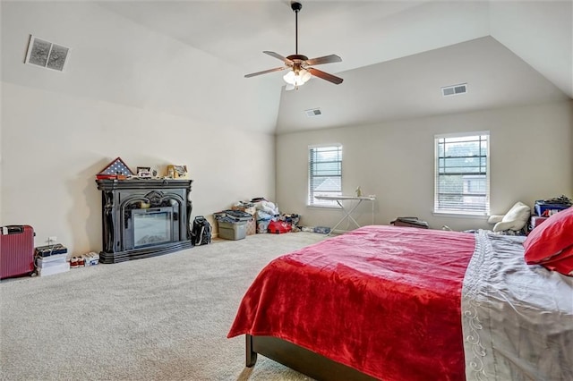 carpeted bedroom featuring visible vents, vaulted ceiling, and a ceiling fan