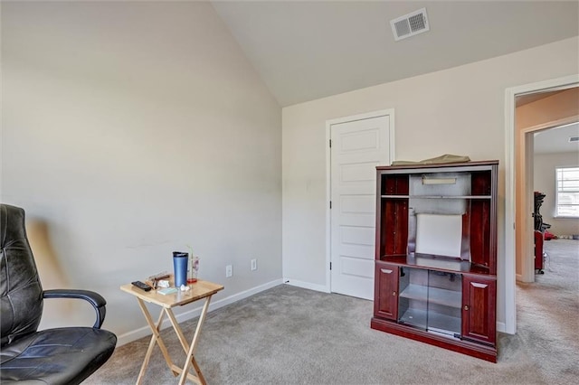 carpeted office featuring visible vents, vaulted ceiling, and baseboards