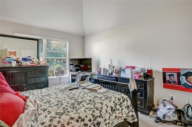 bedroom featuring lofted ceiling and carpet flooring