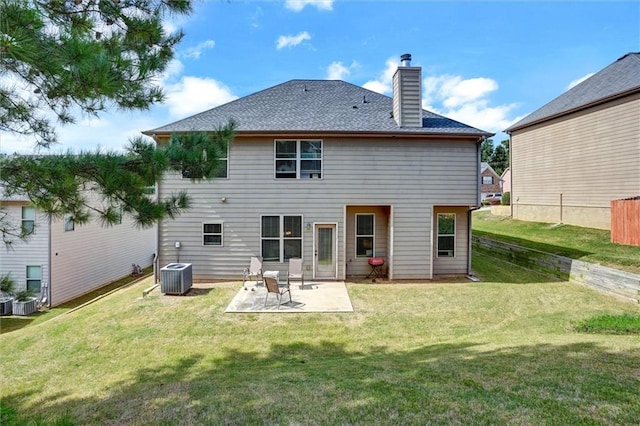 rear view of house with central AC, a patio, a lawn, and a chimney