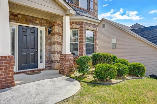 property entrance featuring brick siding