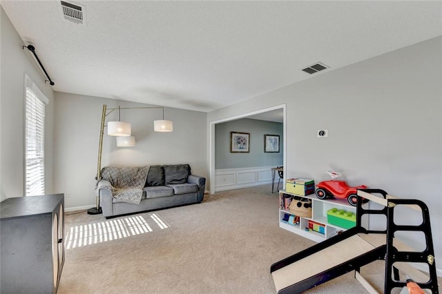 living room with carpet and visible vents