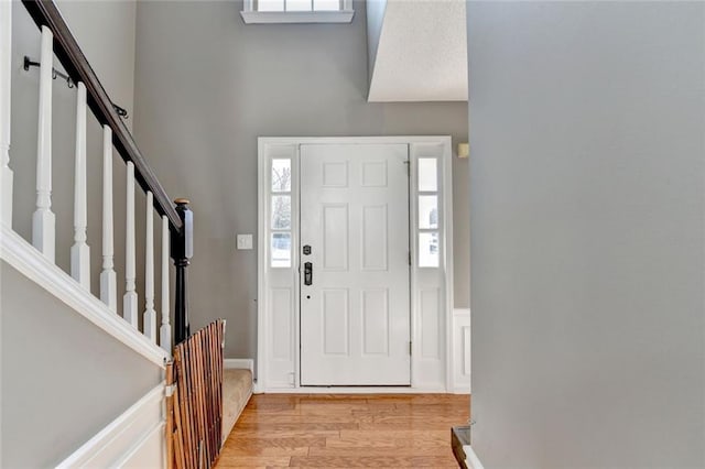 entrance foyer featuring light wood-style flooring and stairs