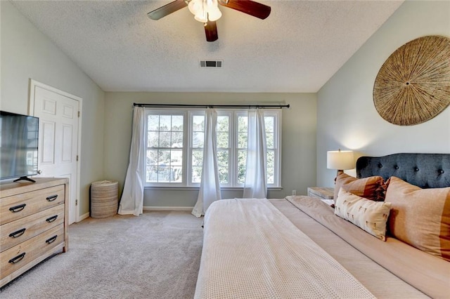 bedroom featuring light carpet, visible vents, a ceiling fan, vaulted ceiling, and a textured ceiling