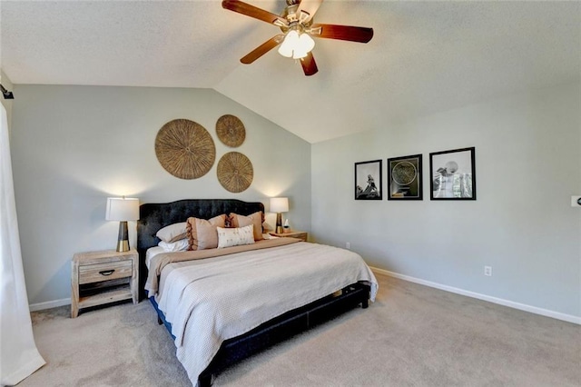 carpeted bedroom featuring a barn door, vaulted ceiling, baseboards, and ceiling fan