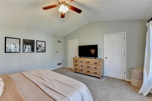 bedroom with carpet floors, visible vents, a ceiling fan, and lofted ceiling