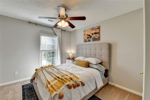 bedroom with light carpet, ceiling fan, a textured ceiling, and baseboards