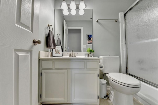 full bath featuring toilet, bath / shower combo with glass door, and vanity