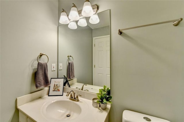 bathroom featuring vanity and toilet