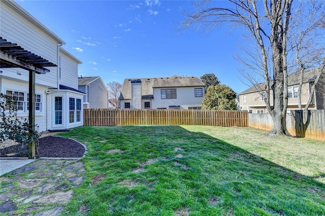 view of yard featuring a fenced backyard and a residential view