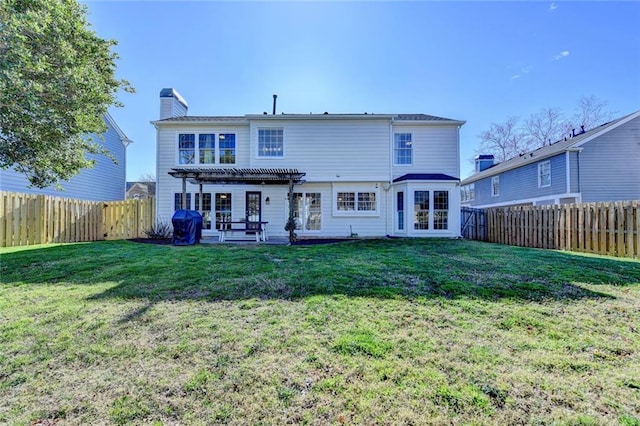 rear view of house featuring a lawn, a chimney, a fenced backyard, and a pergola