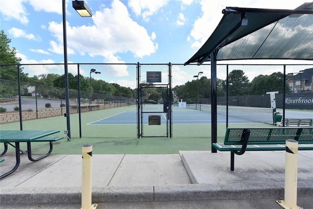 view of sport court with a gate and fence