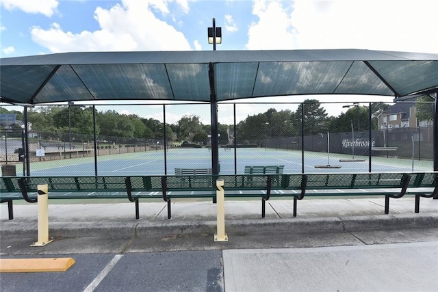 view of tennis court featuring fence