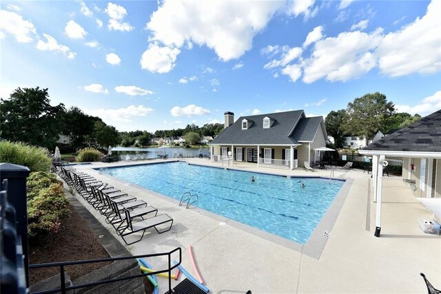 pool with a patio and fence