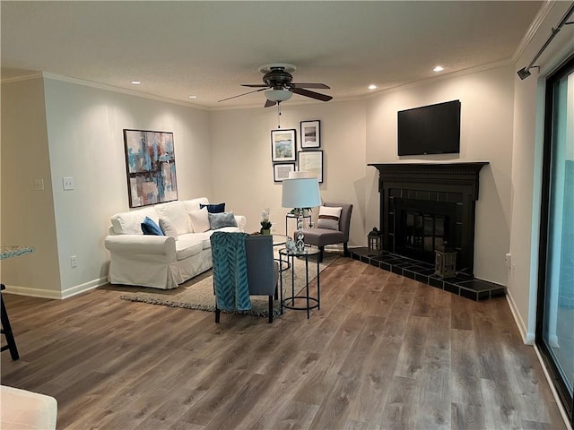 living room with crown molding and wood finished floors