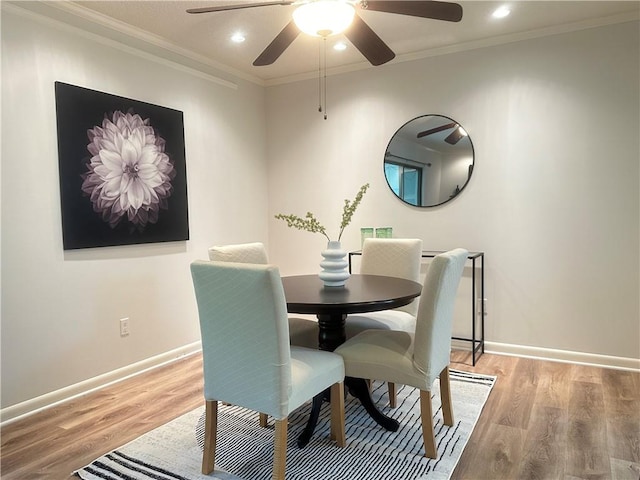 dining room featuring ornamental molding, ceiling fan, and light hardwood / wood-style floors