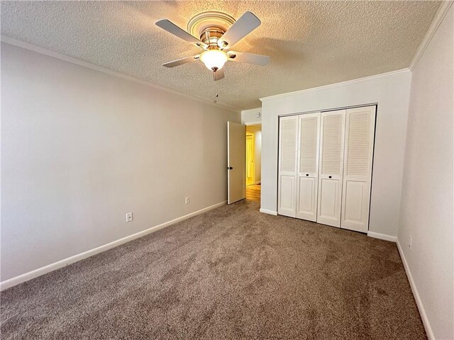 unfurnished bedroom featuring crown molding, carpet, a textured ceiling, and a closet