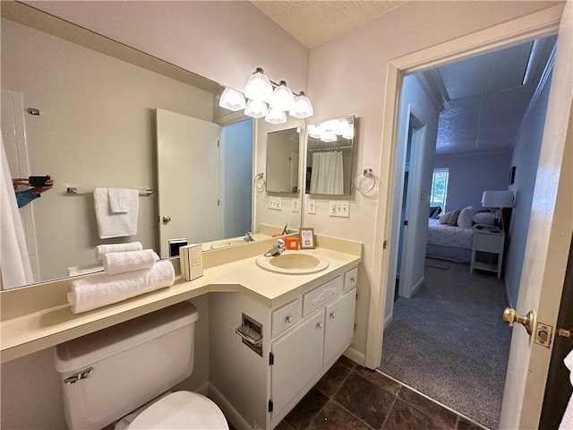 bathroom featuring vanity, toilet, and a textured ceiling