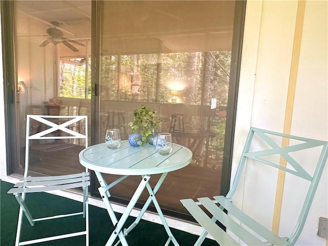 sunroom featuring ceiling fan