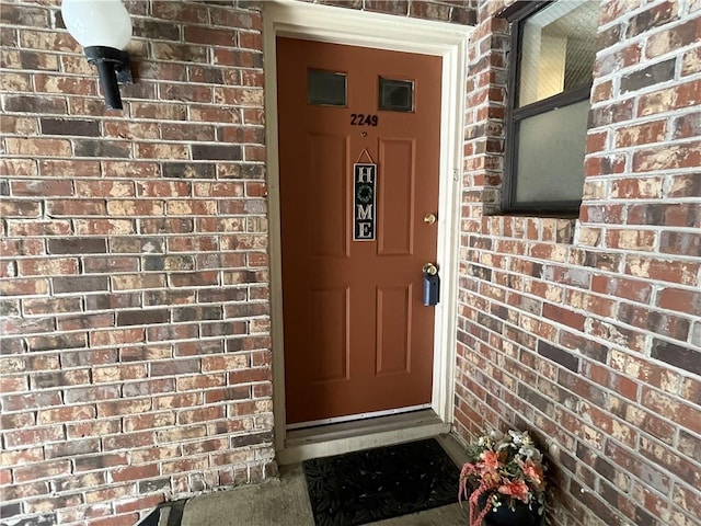 property entrance with brick siding