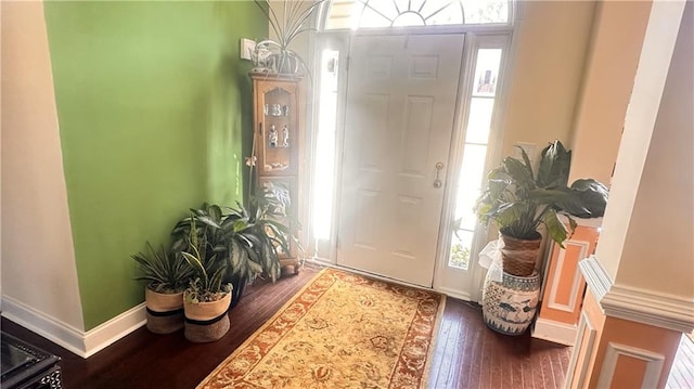 entryway with a healthy amount of sunlight, baseboards, and wood-type flooring