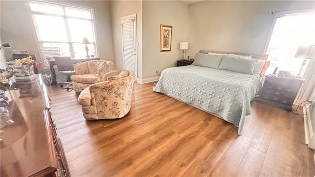 bedroom featuring baseboards and wood finished floors