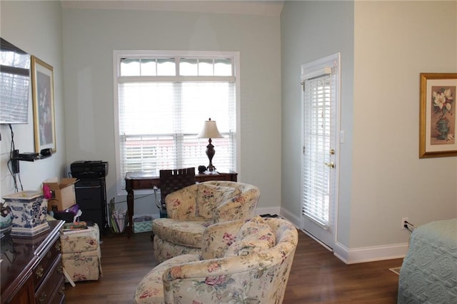 sitting room featuring plenty of natural light, baseboards, and dark wood-style flooring