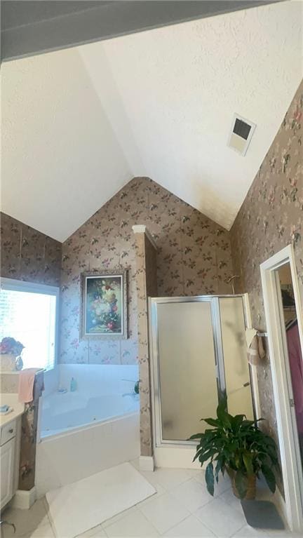 full bathroom featuring visible vents, a shower stall, a garden tub, lofted ceiling, and vanity