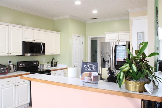 kitchen with black / electric stove, a peninsula, light countertops, white cabinetry, and stainless steel fridge