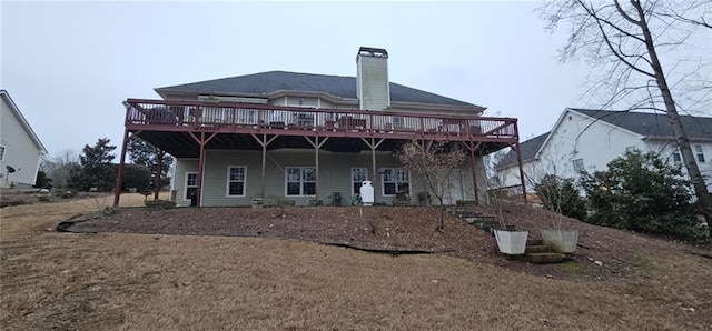 rear view of property with a wooden deck and a chimney