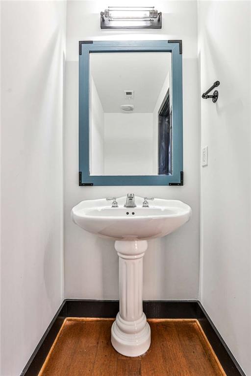 entryway featuring washer / dryer, wood finished floors, electric panel, and baseboards