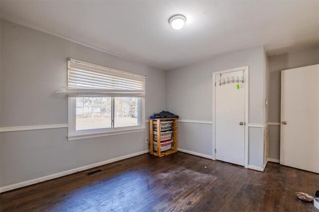 spare room with dark wood-type flooring