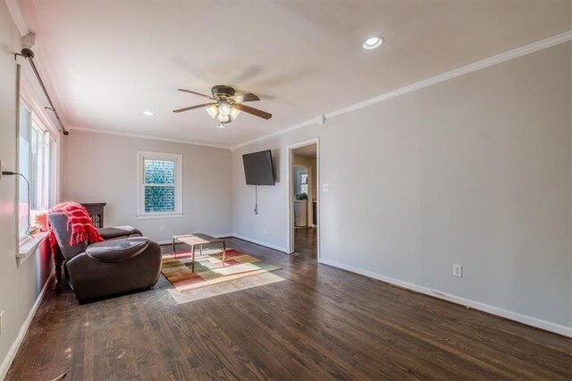 sitting room featuring dark hardwood / wood-style flooring, ceiling fan, and crown molding