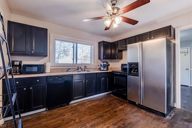 kitchen featuring black appliances, dark hardwood / wood-style floors, ceiling fan, and sink