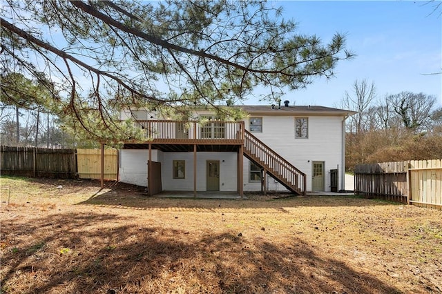 rear view of property with fence, stairway, a patio, and a wooden deck